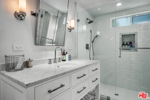 a bathroom with a sink double vanity and a mirror
