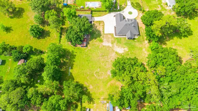 a living room with furniture and a large mirror with wooden floor