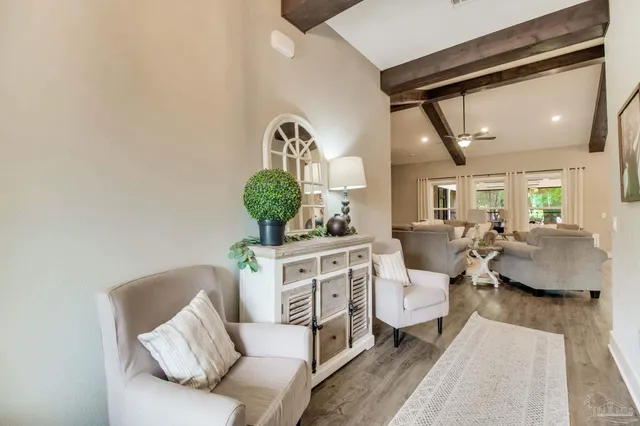 a large white kitchen with lots of counter space a sink appliances and windows