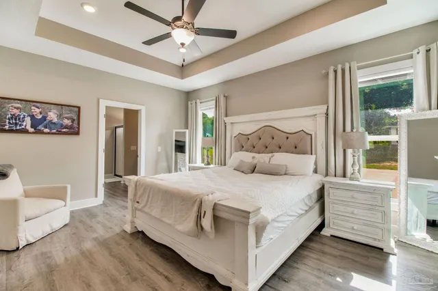 a view of a dining room with furniture large windows and garden view