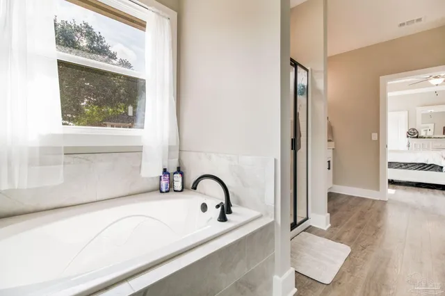 a living room with furniture and large windows