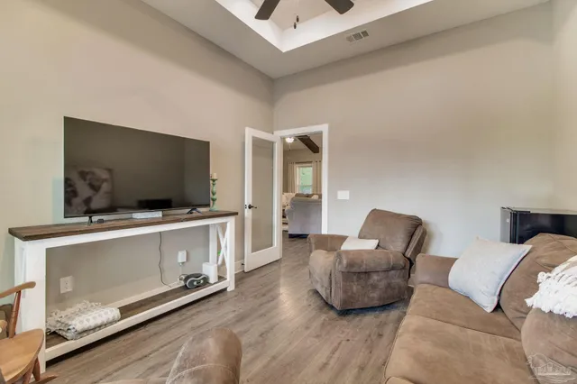 a front view of house with yard and trees in the background