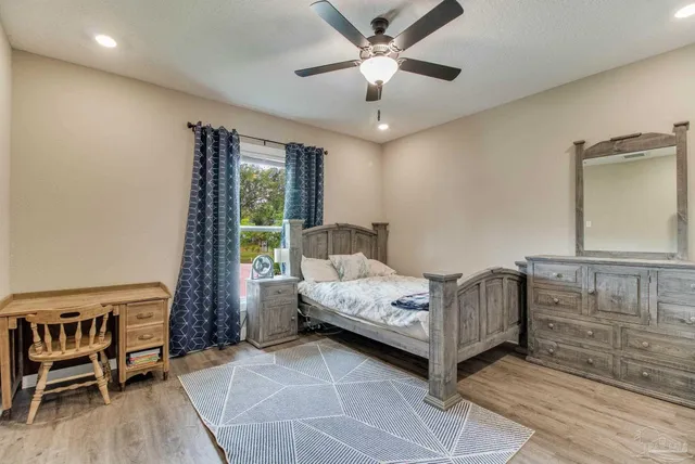 a grassy field with trees in the background