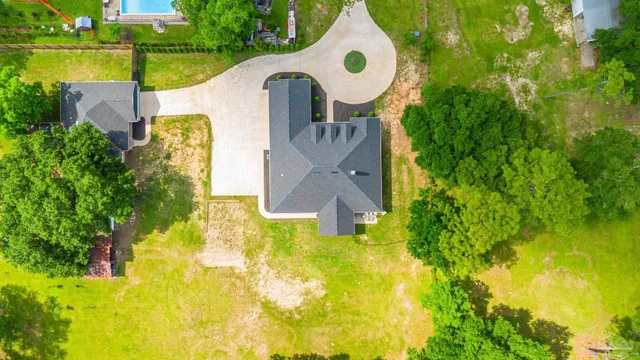 an aerial view of residential houses with outdoor space and garden
