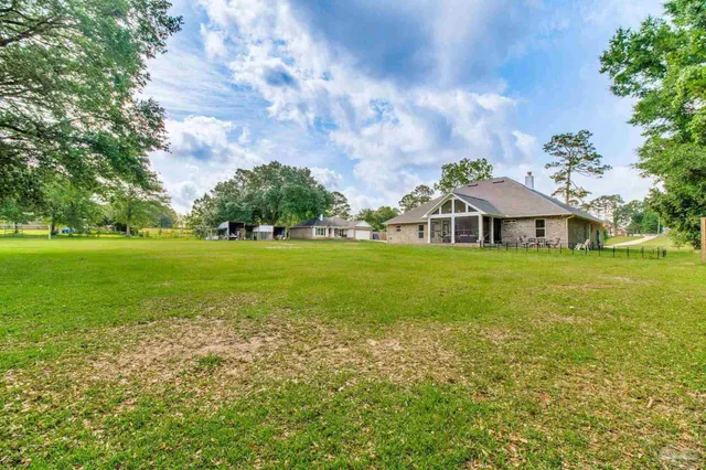 a view of a dining room with furniture and a window