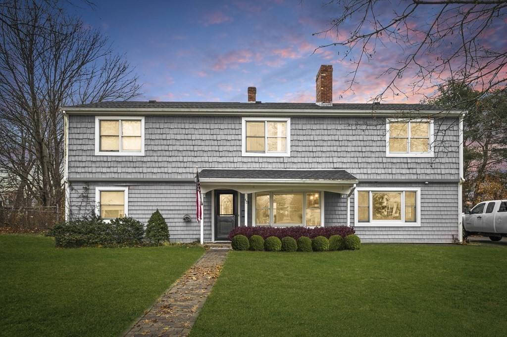a front view of a house with a garden