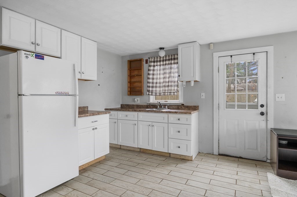 45 Burley Street Danvers, MA 01923 - Photo 13 of 41 a kitchen with granite countertop white cabinets and white appliances