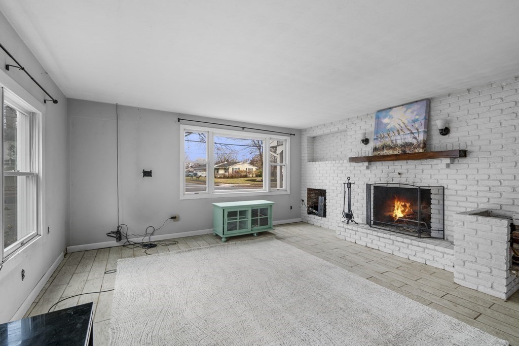 45 Burley Street Danvers, MA 01923 - Photo 16 of 41 a view of a livingroom with furniture a fireplace and window