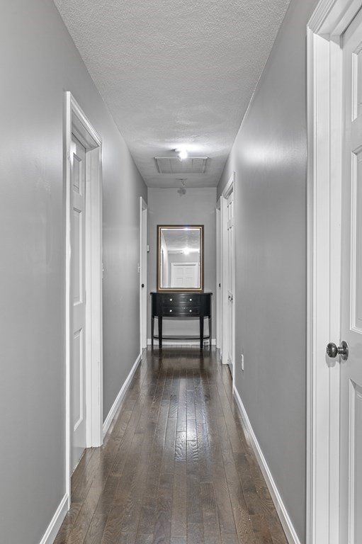 45 Burley Street Danvers, MA 01923 - Photo 20 of 41 a view of a hallway view with wooden floor and furniture