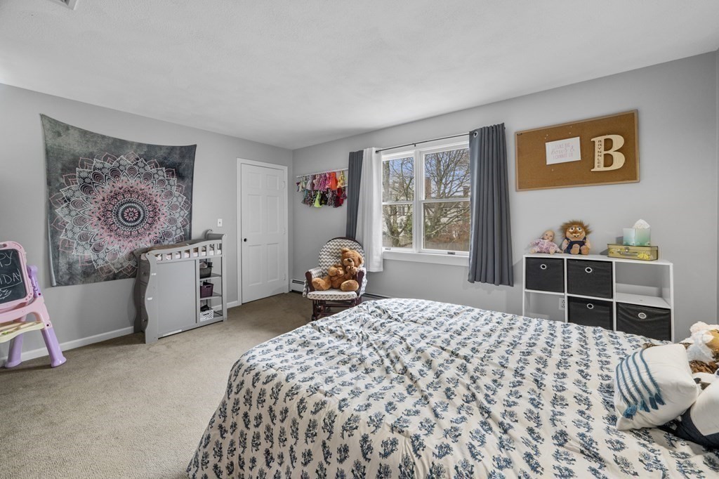 45 Burley Street Danvers, MA 01923 - Photo 23 of 41 a bedroom with a bed and dresser with window