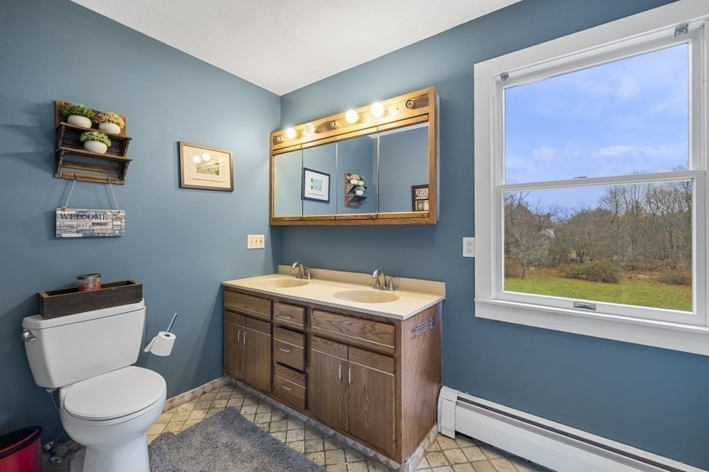 45 Burley Street Danvers, MA 01923 - Photo 25 of 41 a bathroom with a toilet a sink and a mirror