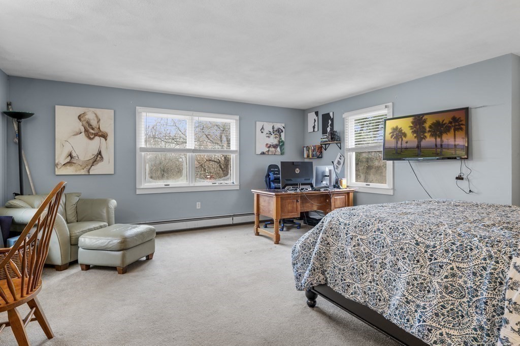 45 Burley Street Danvers, MA 01923 - Photo 28 of 41 a bedroom with furniture and a flat screen tv