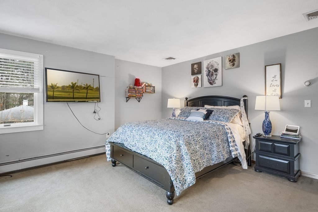 45 Burley Street Danvers, MA 01923 - Photo 29 of 41 a bedroom with a bed and a cabinets