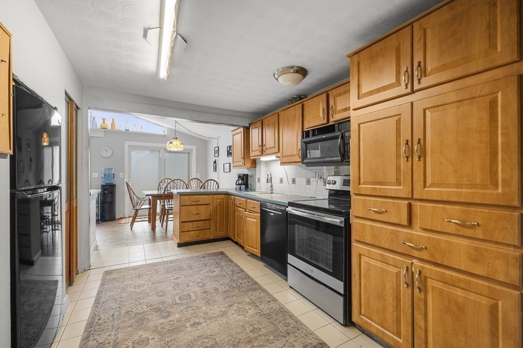 45 Burley Street Danvers, MA 01923 - Photo 9 of 41 a kitchen with stainless steel appliances granite countertop a refrigerator stove top oven and sink