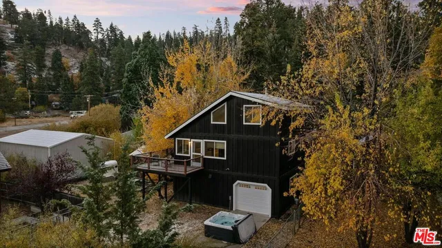 a backyard of a house with wooden floor and outdoor seating