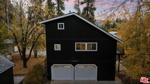 a front view of a house with trees