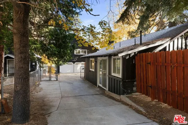 a view of a pathway of a house with wooden fence