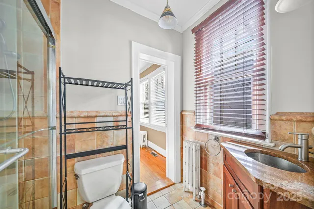 a kitchen with granite countertop a refrigerator and a sink