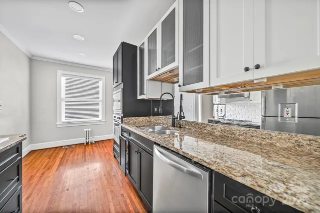 a kitchen with stainless steel appliances granite countertop a sink and stove