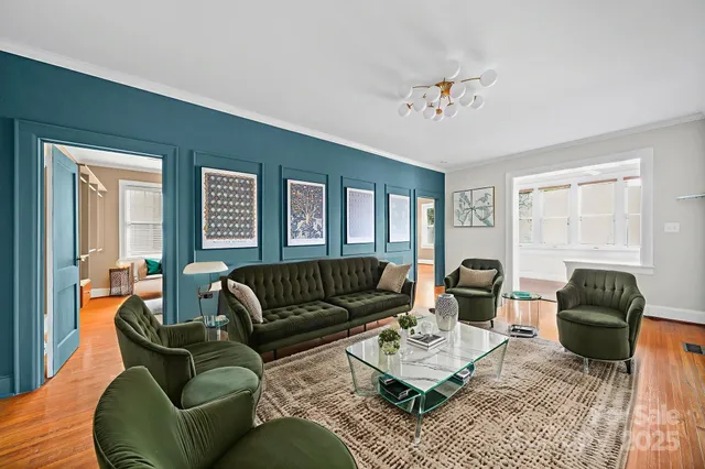 a living room with furniture ceiling fan and a window