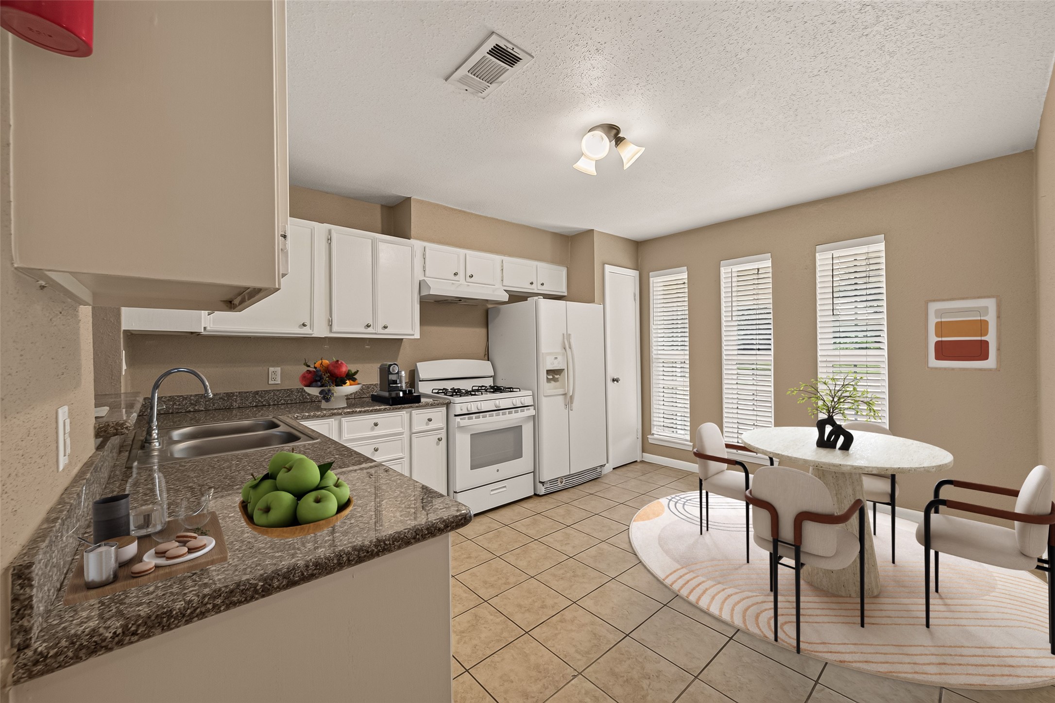 719 Kilpatrick Street Channelview, TX 77530 - Photo 4 of 40 The kitchen offers granite countertops, ample cabinet storage, and windows that bring in natural light from the nearby dining area. *virtually staged