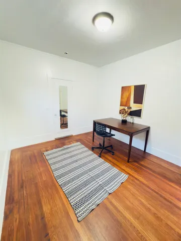 a bedroom with a bed and a desk