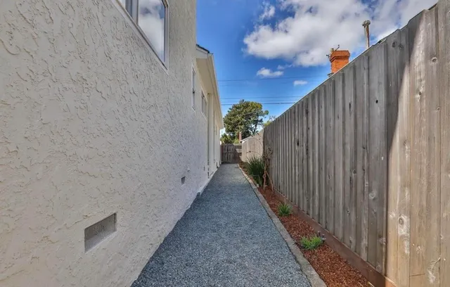 a view of a pathway gate with wooden fence