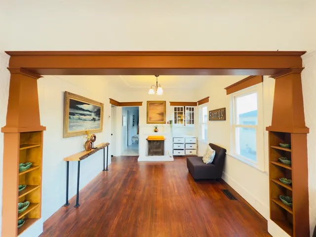 a living room with furniture and a wooden floor