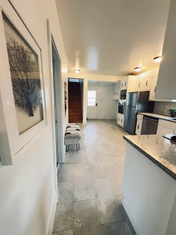 a room with a washing machine and sink