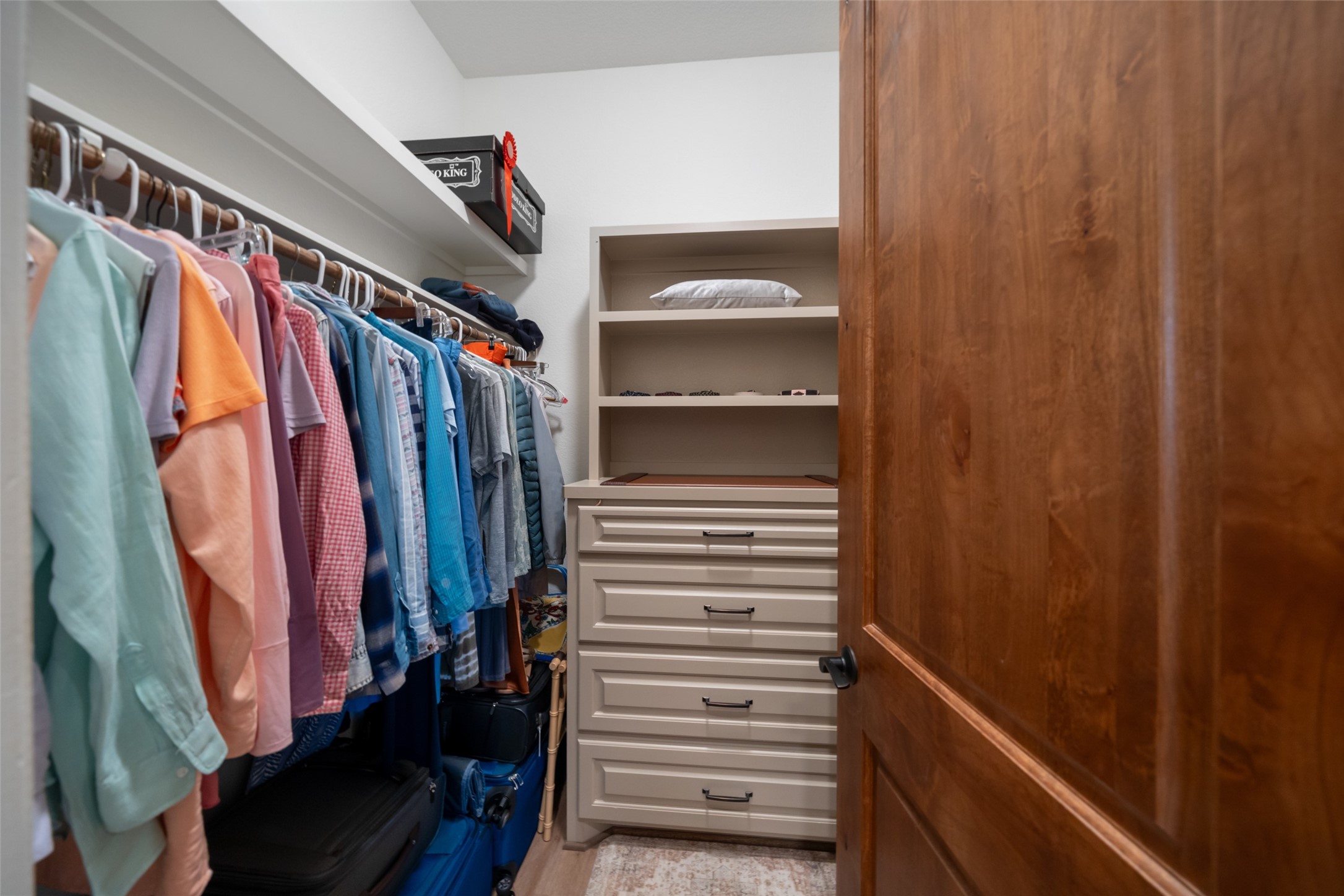 30163 High Spirit Ranch Road Hempstead, TX 77445 - Photo 23 of 47 The custom walk-in closet offers
built-in drawers, open shelving, and
extensive hanging space.