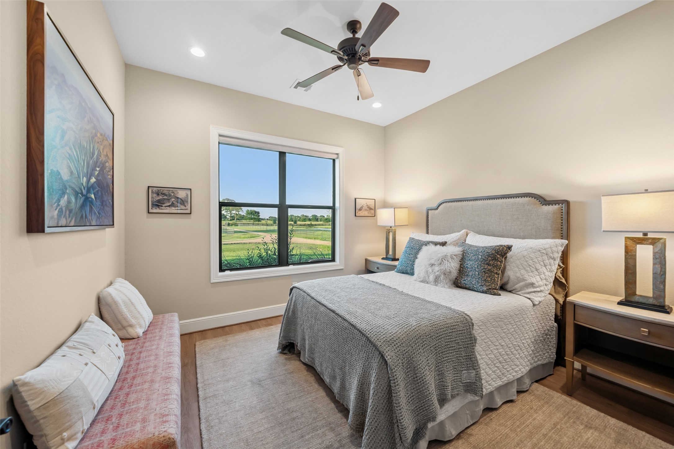 30163 High Spirit Ranch Road Hempstead, TX 77445 - Photo 25 of 47 This serene secondary front
bedroom features a large window
with tranquil pasture views, recessed
lighting, and natural light create a
cozy and restful space.