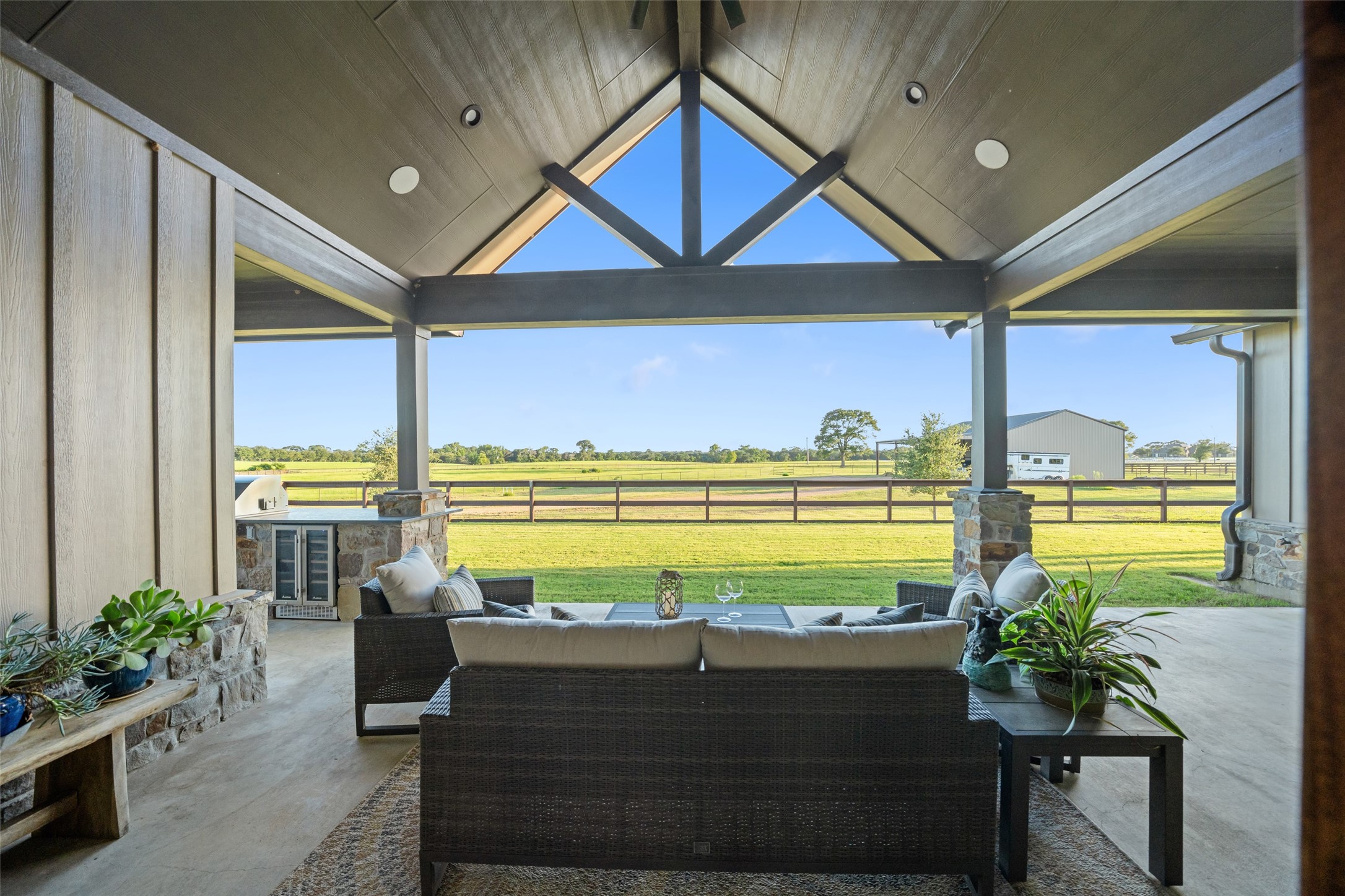30163 High Spirit Ranch Road Hempstead, TX 77445 - Photo 31 of 47 Enjoy panoramic views of the fenced
pastures from the expansive covered
patio, complete with soaring woodbeamed ceilings and ample space
for outdoor seating and entertaining.