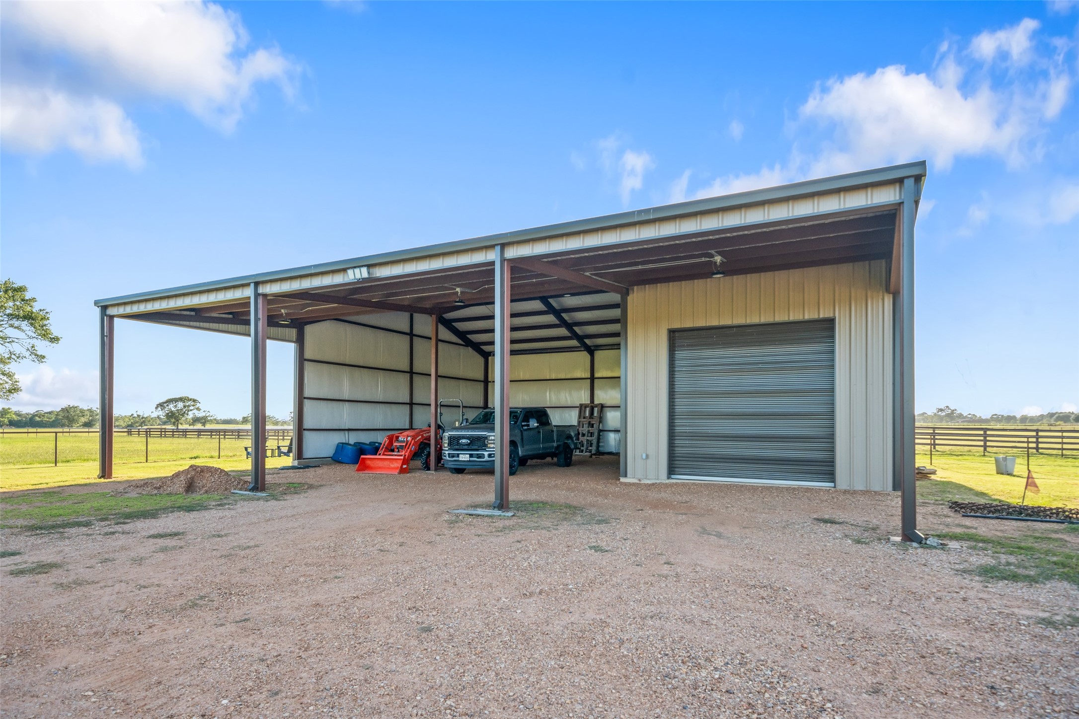 30163 High Spirit Ranch Road Hempstead, TX 77445 - Photo 45 of 47 A 40'x60' metal equipment building
features covered storage bays, a
14'x12' roll-up door for a class A RV,
and plenty of room for tractors,
trailers, and ranch tools