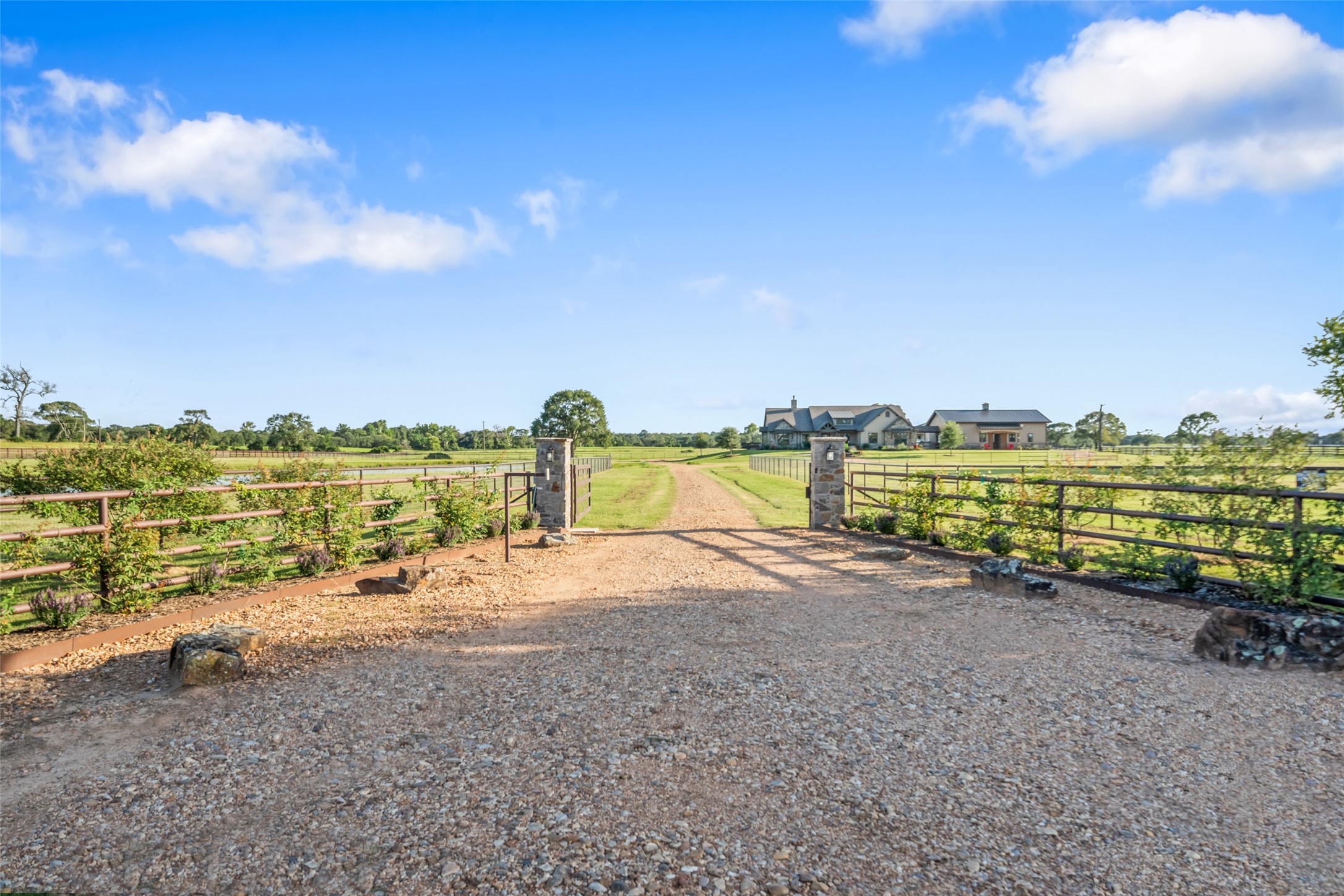30163 High Spirit Ranch Road Hempstead, TX 77445 - Photo 5 of 47 The secure electric gate opens to a
long gravel drive flanked by pipe
fencing, creating a sense of privacy
from the moment you arrive.