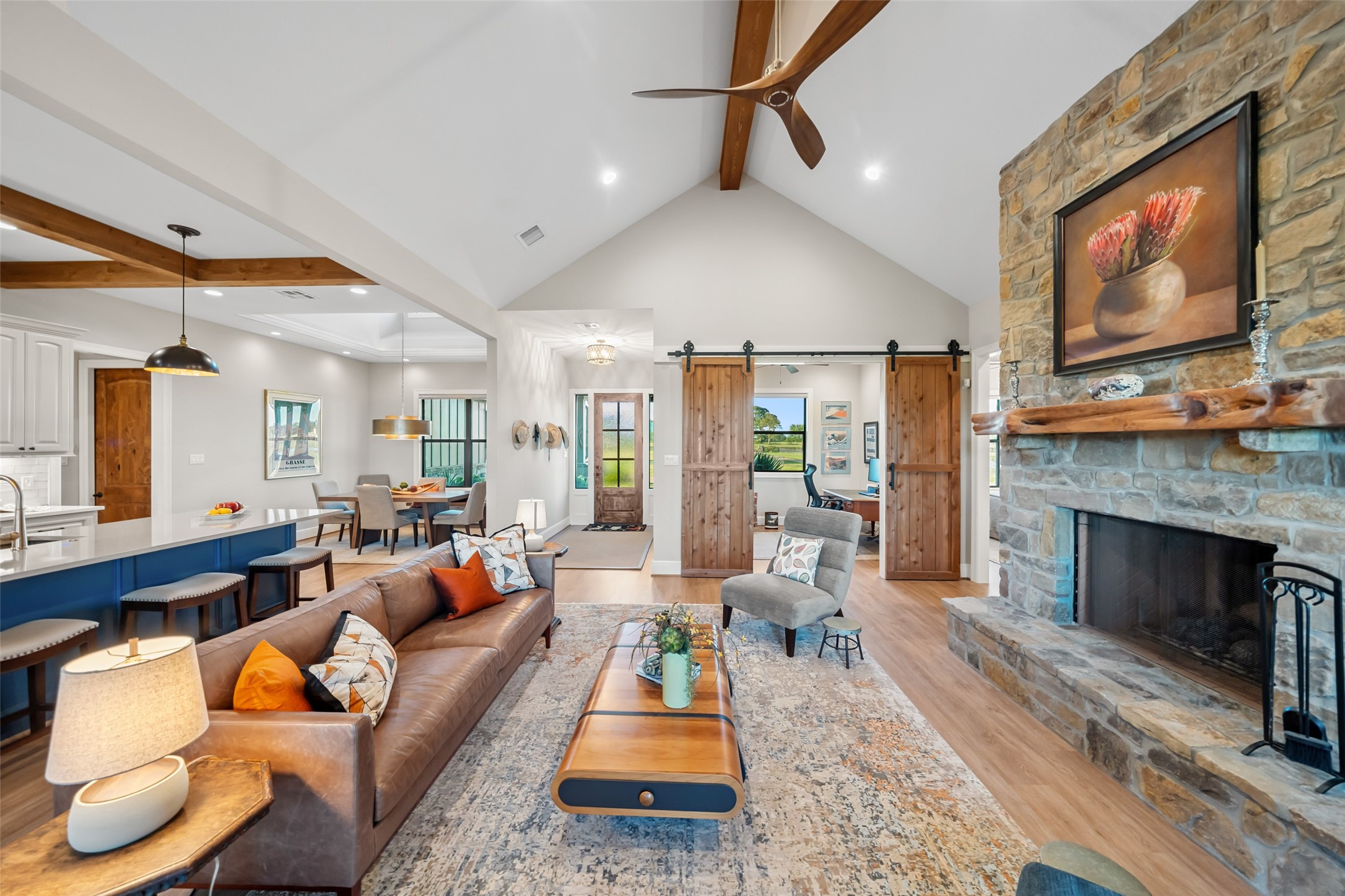 30163 High Spirit Ranch Road Hempstead, TX 77445 - Photo 9 of 47 Vaulted ceilings and exposed beams
elevate the living space, while dual
sliding barn doors lead into a private
study with custom built-ins.