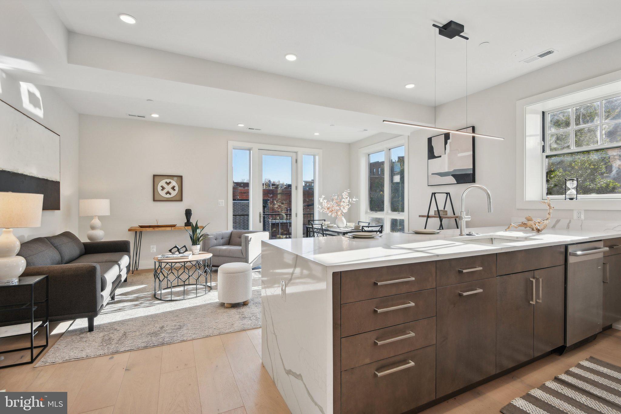 a living room with kitchen island granite countertop furniture and fireplace