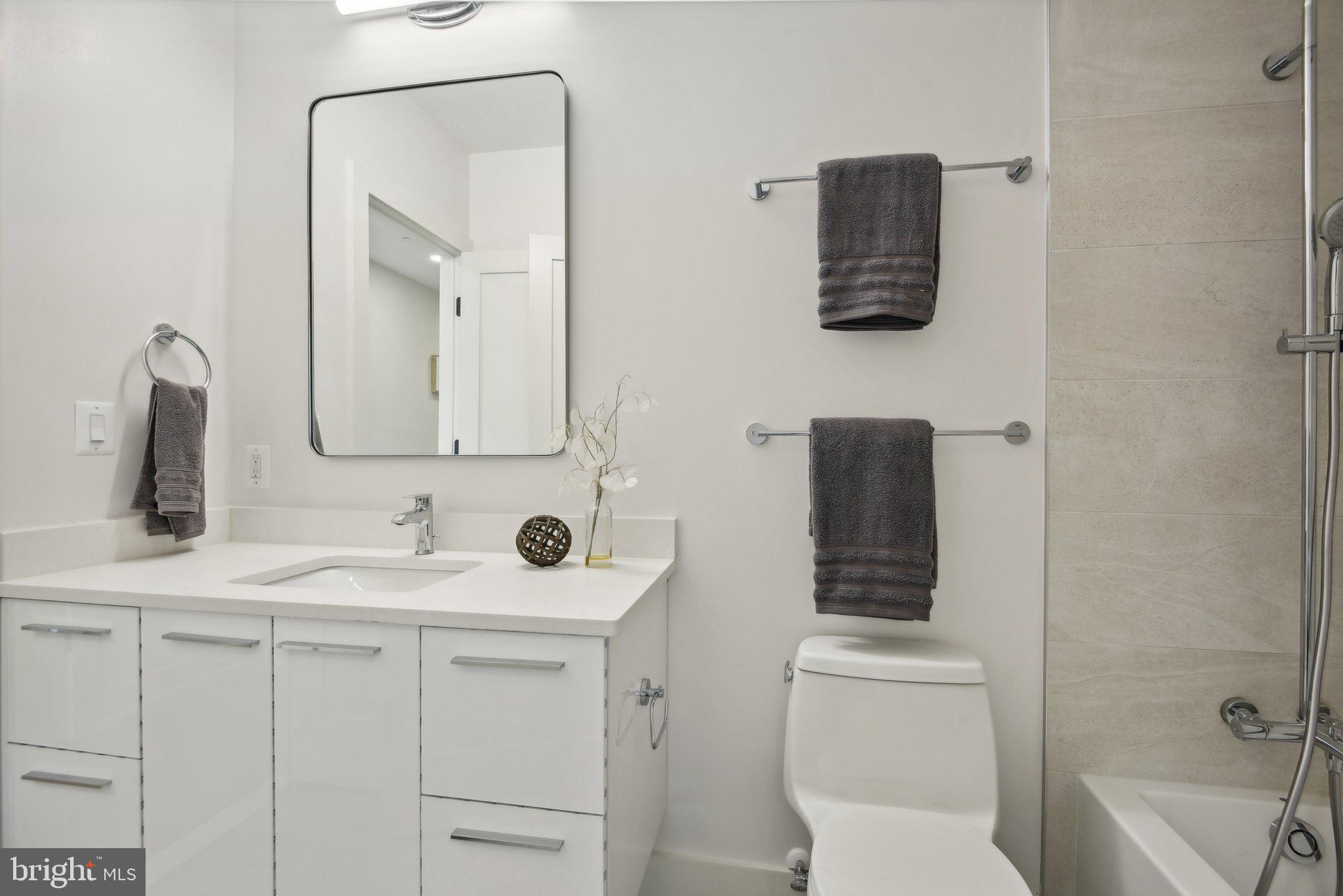 1748 Lanier Place Northwest, Unit 2 Washington, DC 20009 - Photo 20 of 33 a bathroom with a toilet sink and mirror