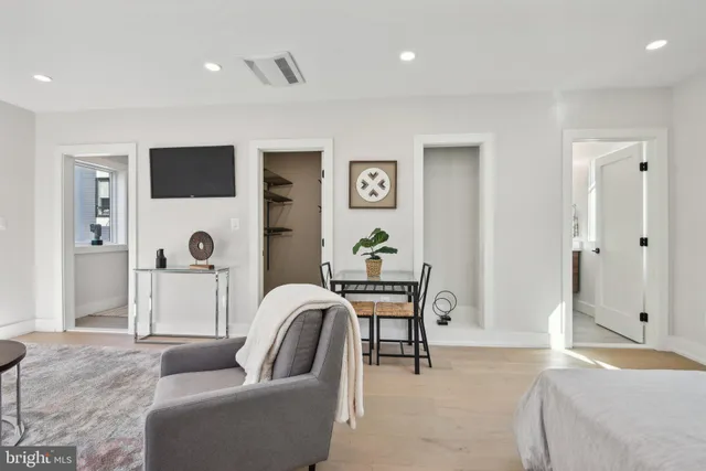 a bathroom with a chair and the shower