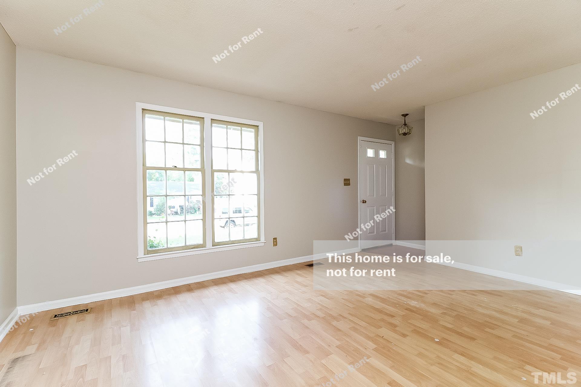 3729 Dusty Lane Raleigh, NC 27604 - Photo 3 of 27 a view of an empty room with wooden floor and a window