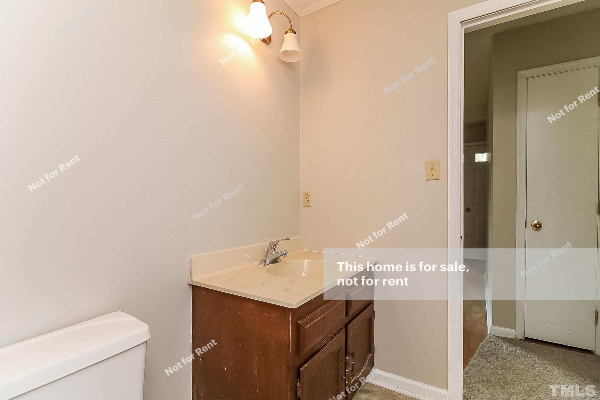 3729 Dusty Lane Raleigh, NC 27604 - Photo 24 of 27 a bathroom with a sink a toilet and vanity