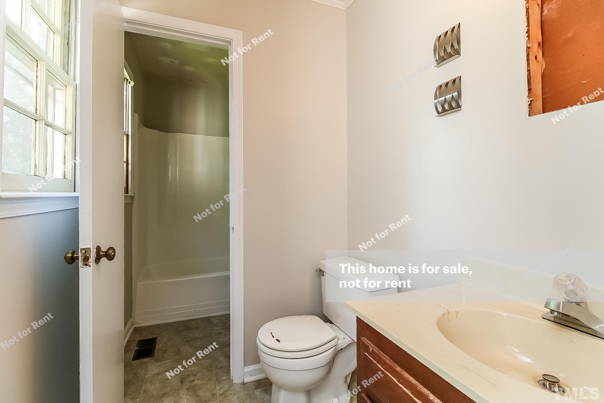 3729 Dusty Lane Raleigh, NC 27604 - Photo 25 of 27 a bathroom with a sink toilet and shower