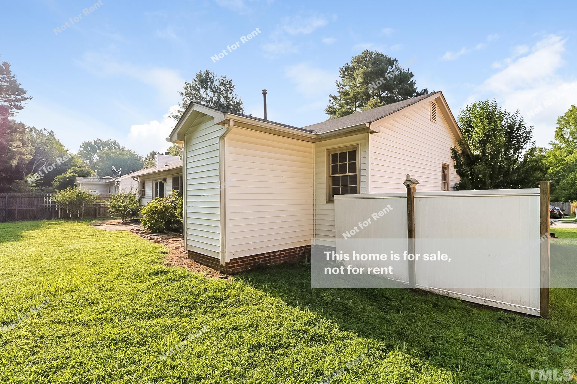 3729 Dusty Lane Raleigh, NC 27604 - Photo 26 of 27 a front view of a house with a yard and garage