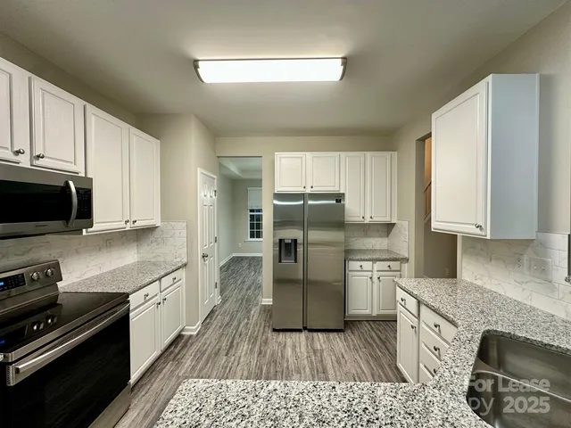 a kitchen with a refrigerator stove and microwave