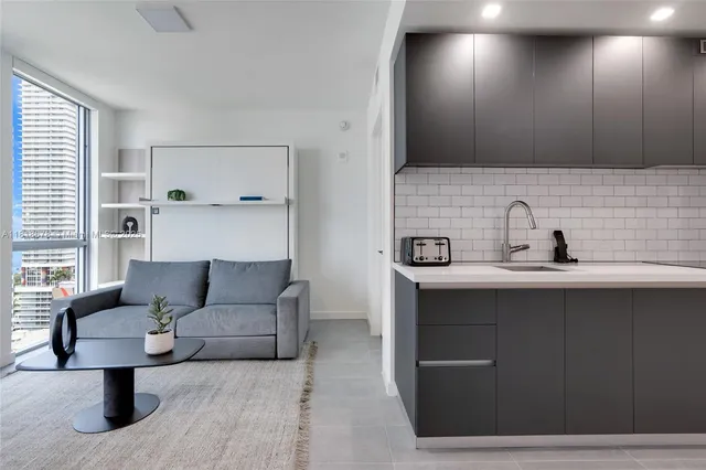 a living room with furniture and a potted plant