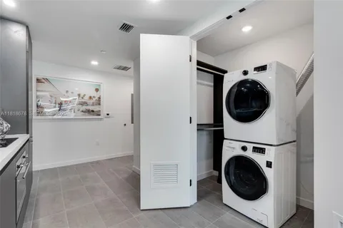 a view of a hallway with washer and dryer