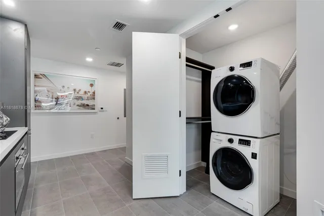 a view of a hallway with washer and dryer