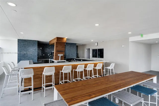 a view of a dining room with furniture a chandelier and wooden floor