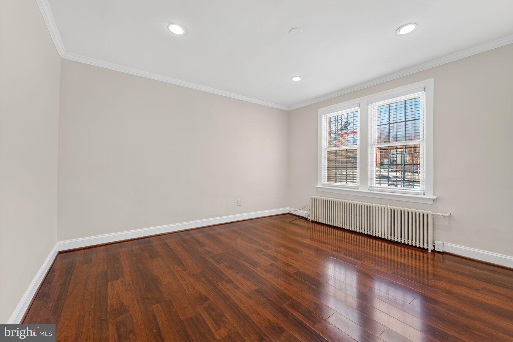 1618 18th Street Southeast, Unit 1 Washington, DC 20020 - Photo 6 of 21 an empty room with wooden floor and windows