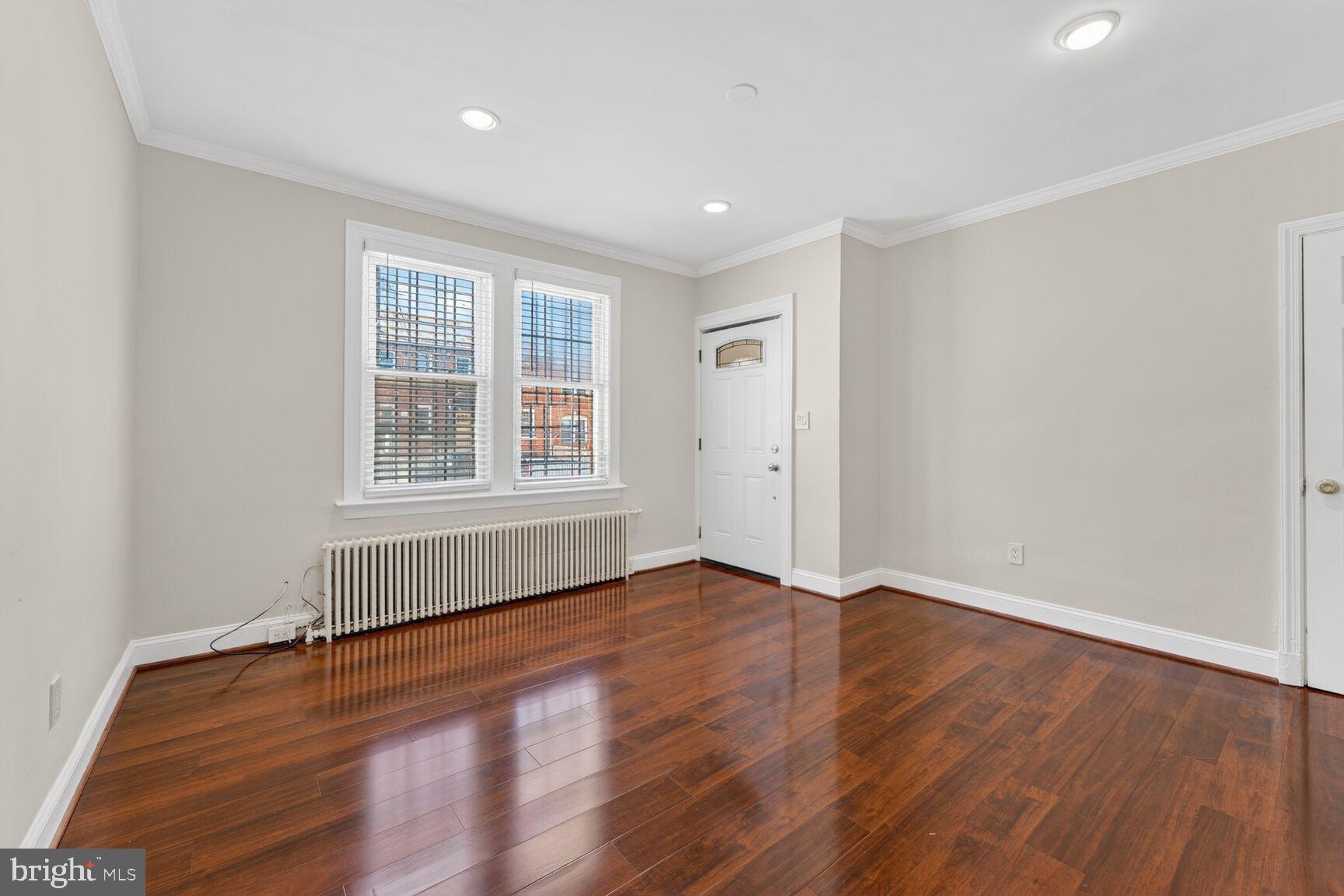 1618 18th Street Southeast, Unit 1 Washington, DC 20020 - Photo 7 of 21 an empty room with wooden floor and windows