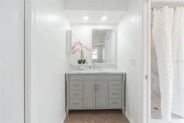 a bathroom with a granite countertop sink a mirror and a